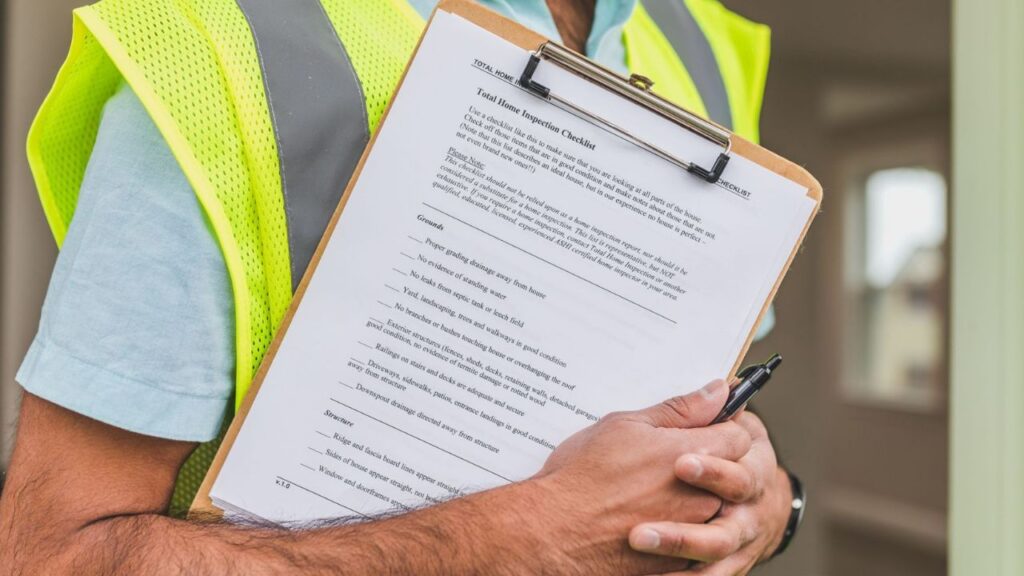 Technician holding an HVAC maintenance checklist during a system inspection.