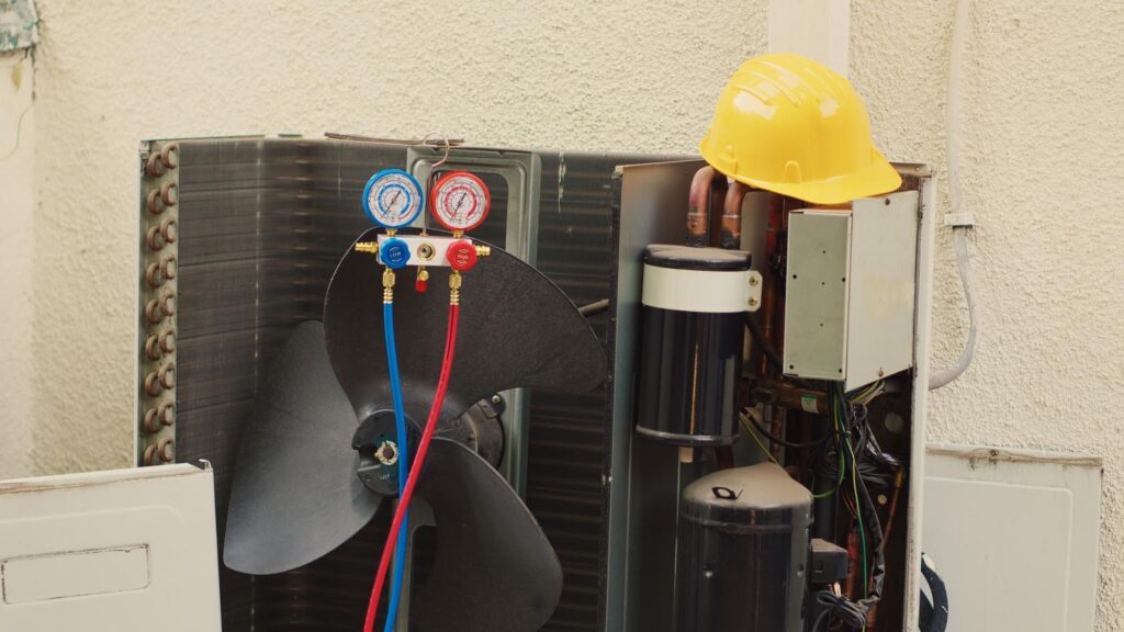 AC condenser with manifold gauges attached for pressure testing.
